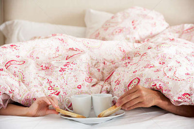 4348736_stock-photo-couples-hands-reaching-from-under-duvet-for-breakfast.jpg